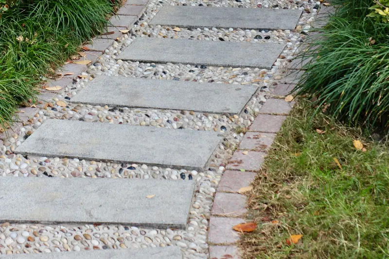 A landscaped path bordered by ornamental grasses